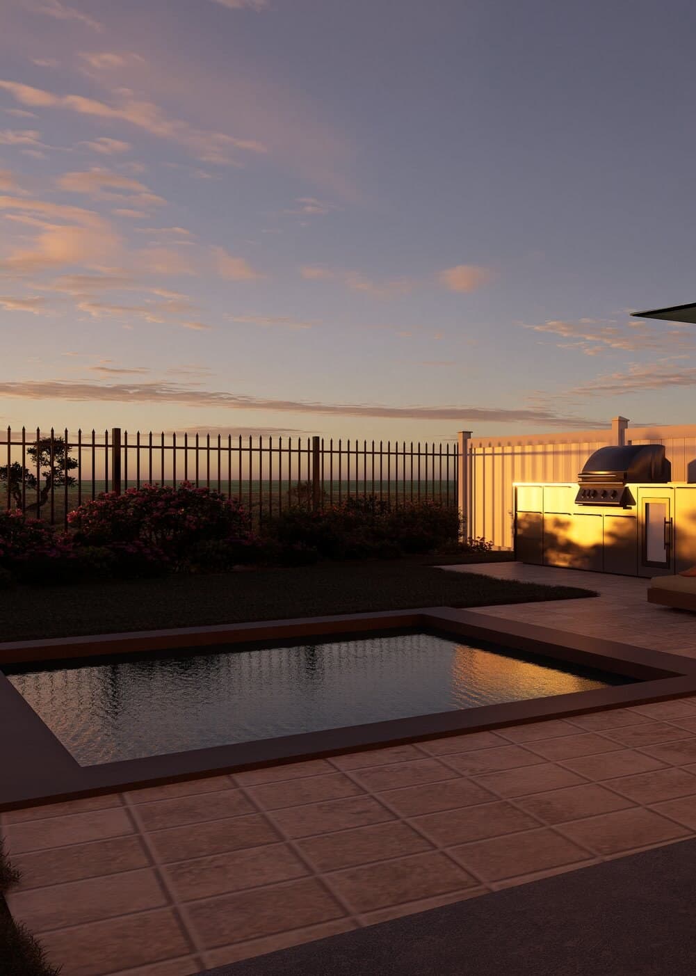 Ground-floor patio and pool at dusk, with the outdoor kitchen lit